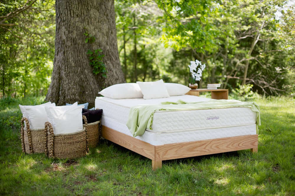 Twin XL Savvy Rest Serenity Organic Latex mattress displayed outdoors, showcasing its natural materials and peaceful setting.