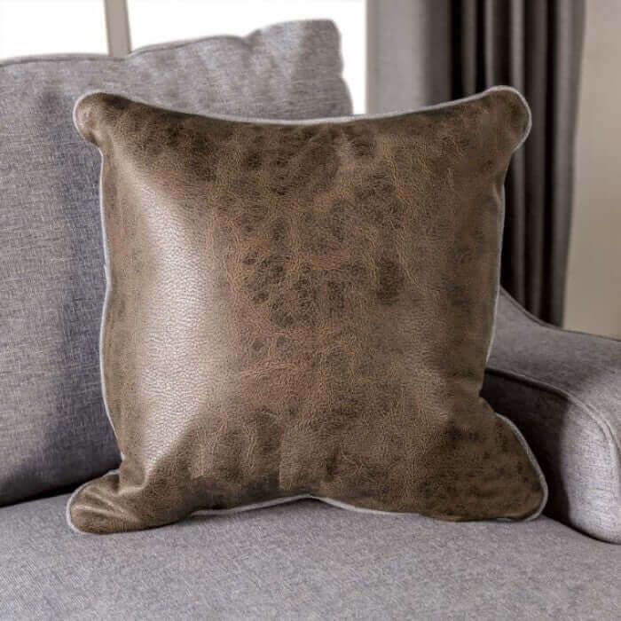 Soft brown decorative throw pillow on a gray couch, adding warmth to a stylish living room ensemble.
