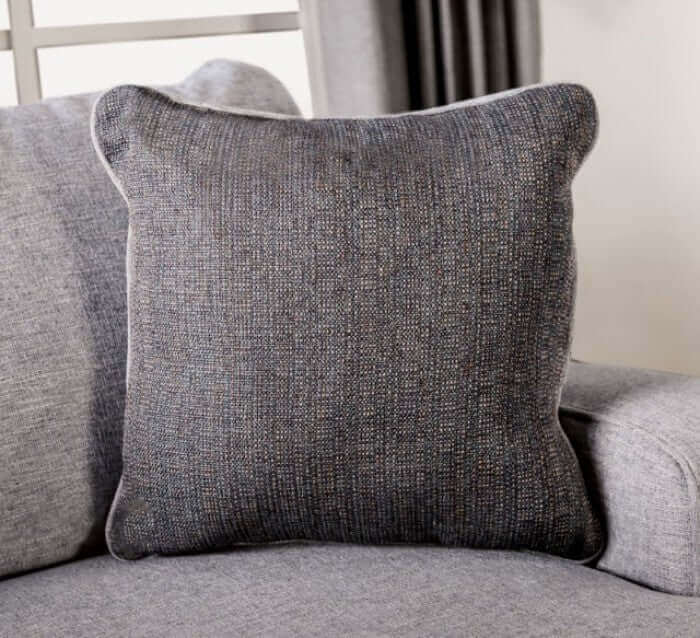 Soft gray throw pillow with textured fabric, complementing the Skyline Gray Loveseat in a stylish living room setting.