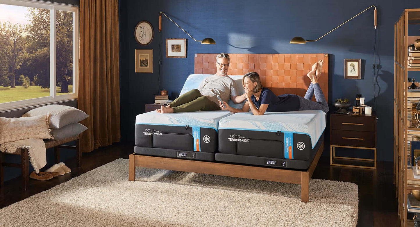 Couple relaxing on a bed with TEMPUR-Ergo® Smart Adjustable Base, showcasing comfort and advanced sleep technology.
