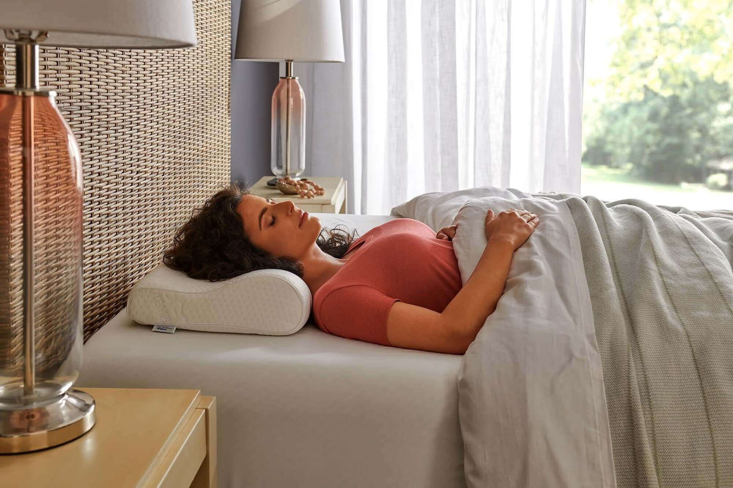 Woman peacefully sleeping with Tempur-Pedic Tempur-Neck Firm Pillow, designed for ergonomic support and comfort.