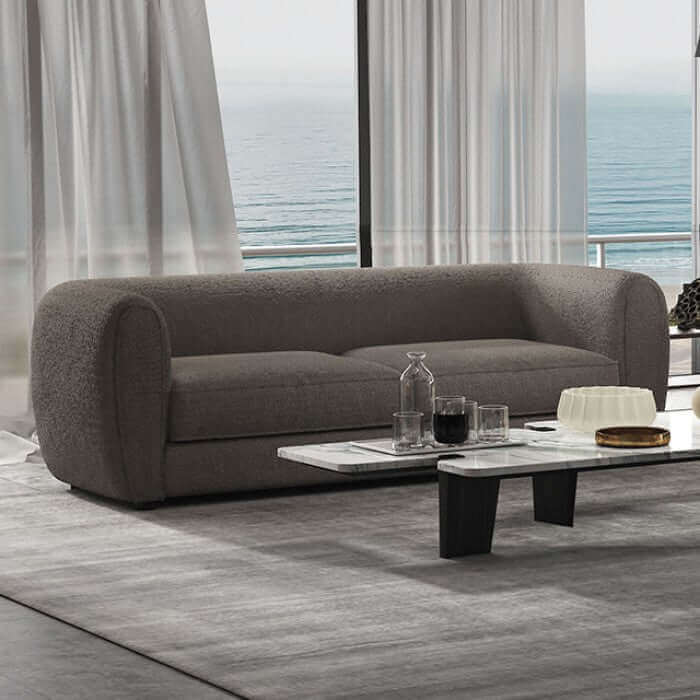 Verdal Gray Contemporary Sofa with rounded design in elegant living room setting overlooking the ocean.
