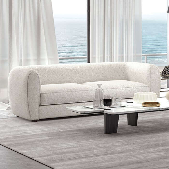 Verdal Off White Contemporary Sofa with smooth lines and soft boucle fabric, set against a bright, airy living room backdrop.