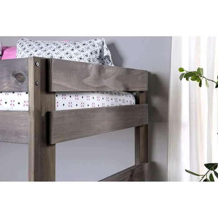 Close-up of Arlette brushed gray rustic pine wood bunk bed showcasing the sturdy headboard and floral patterned bedding.