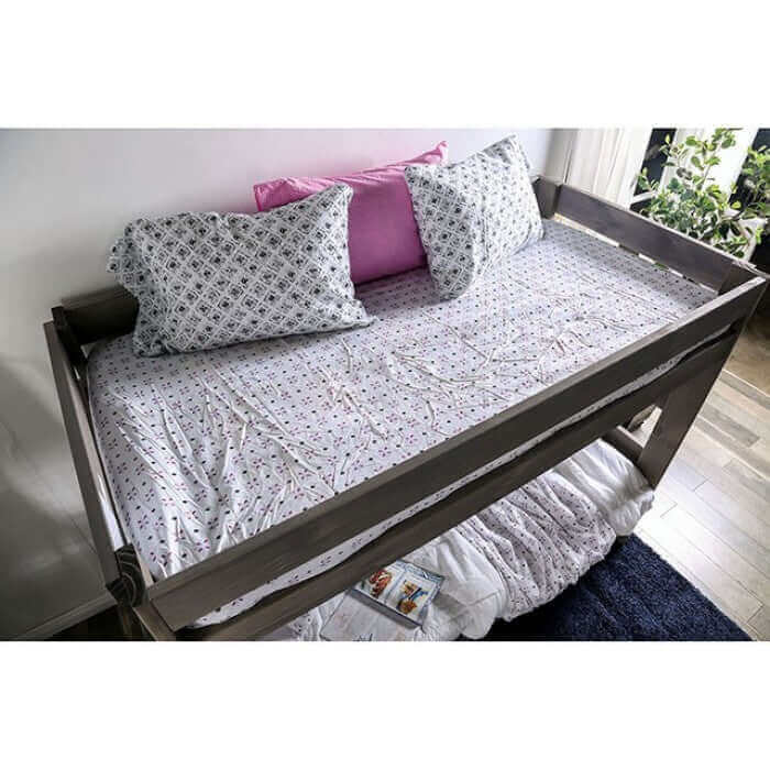 Arlette brushed gray rustic pine wood bunk bed with cozy bedding and decorative pillows in a stylish interior setting.