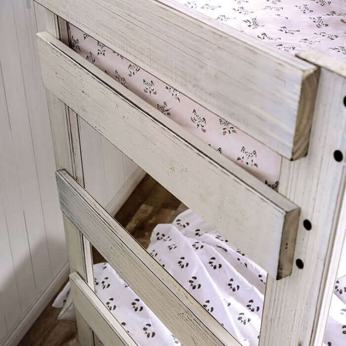 Close-up of Arlette rustic white pine wood bunk bed showcasing the plank design and cozy bedding. Perfect for cottage decor.
