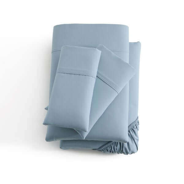 Malouf Pacific Soft Knit Microfiber Sheet Set in soft blue color, featuring pillowcases and fitted sheets with a smooth finish.