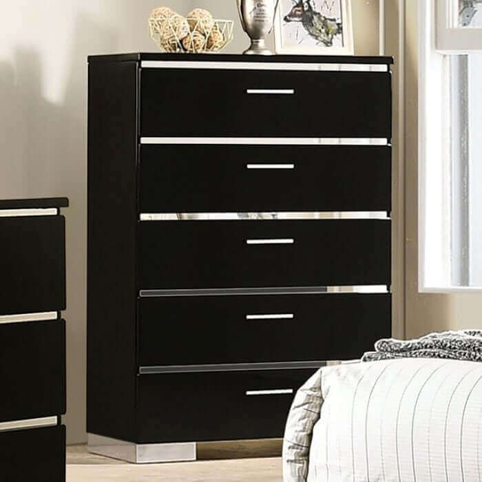 Gloss black dresser with chrome accents and five spacious drawers against a cozy bedroom backdrop.