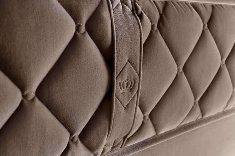 Close-up of Chattam & Wells Windsor mattress detailing with luxurious tufted fabric and logo.