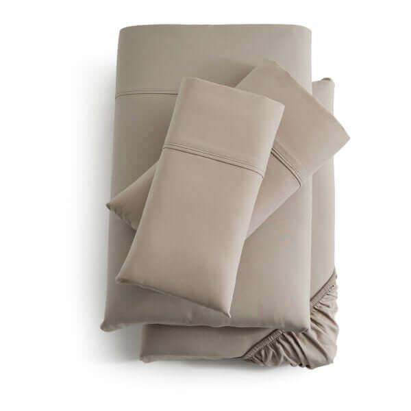Malouf Driftwood Soft Knit Microfiber Sheet Set featuring cozy, double-brushed fabric in a light tan color for luxurious comfort.