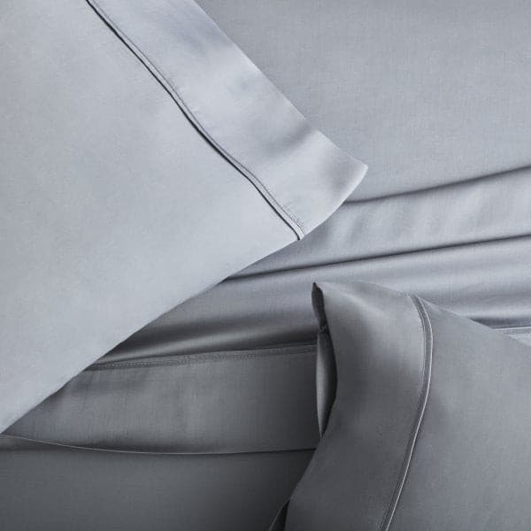 Soft gray Tencel™ Lyocell pillowcase set featuring sateen weave on a smooth bedding surface.