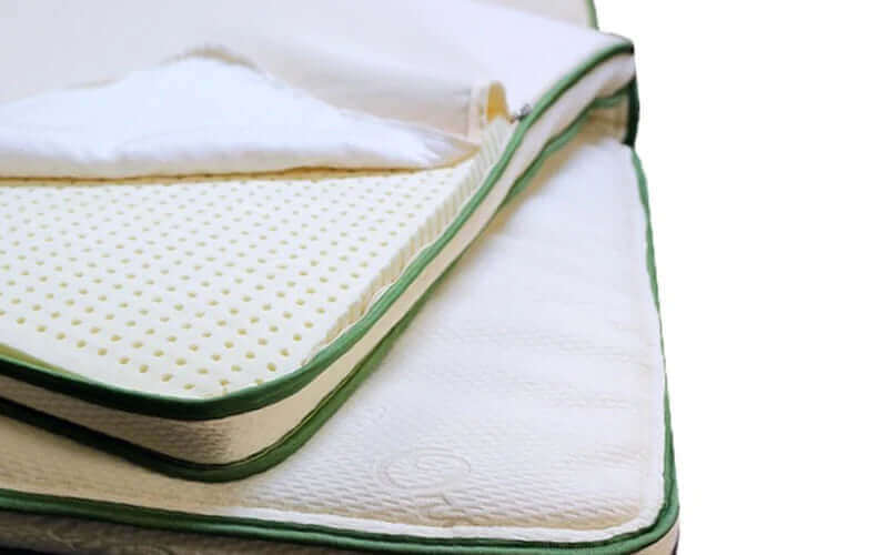 Harvest Green Soft Natural Latex 2.75" Topper on a mattress showcasing plush texture and organic materials.