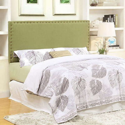 Herstal green fabric headboard with button tufting in a contemporary bedroom setting, paired with a leaf-patterned bedding set.