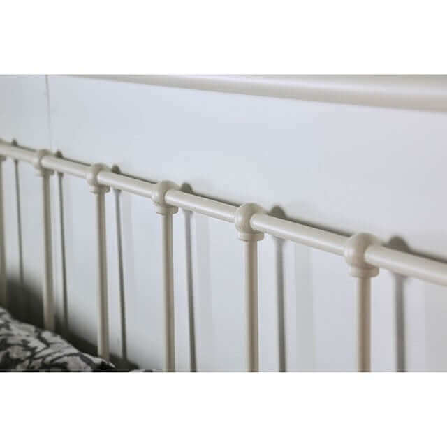 Close-up of the Iria White Metal Bed's headboard showcasing eight spindles and powder-coated finish.
