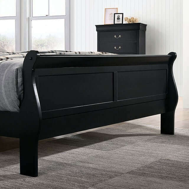 Louis Philippe black slate sleigh bed with matching nightstand in a stylish master bedroom setting.