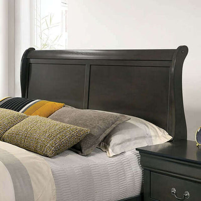 Louis Philippe gray slate sleigh bed headboard with decorative pillows in a stylish master bedroom setting.