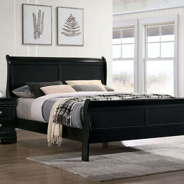 Louis Philippe black slate sleigh bed in a modern master bedroom with decorative wall art and cozy bedding.