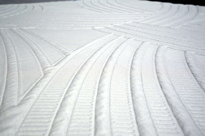 Close-up of the Twin XL Venus Luxe Hybrid mattress cover featuring intricate quilted patterns and soft texture.