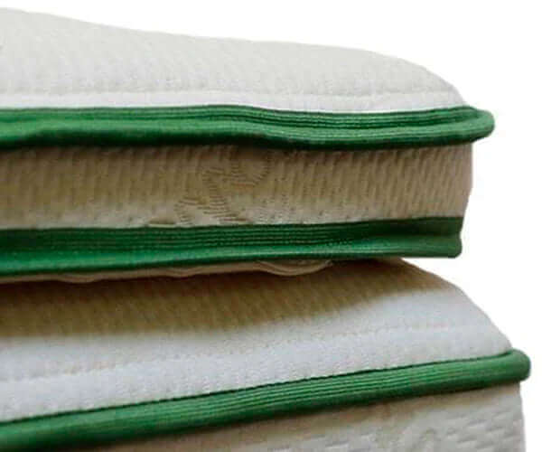 Close-up of Harvest Green Soft Natural Latex mattress topper featuring organic cotton and plush edges.