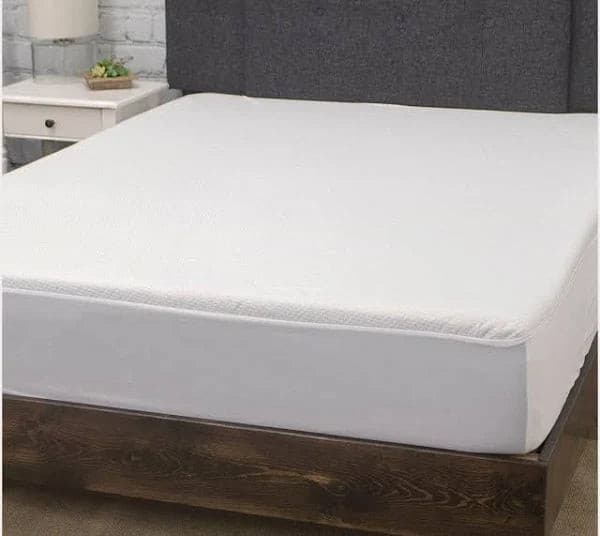 Premium cotton terry cloth waterproof mattress protector on a bed, providing safety and comfort for kids and pets.