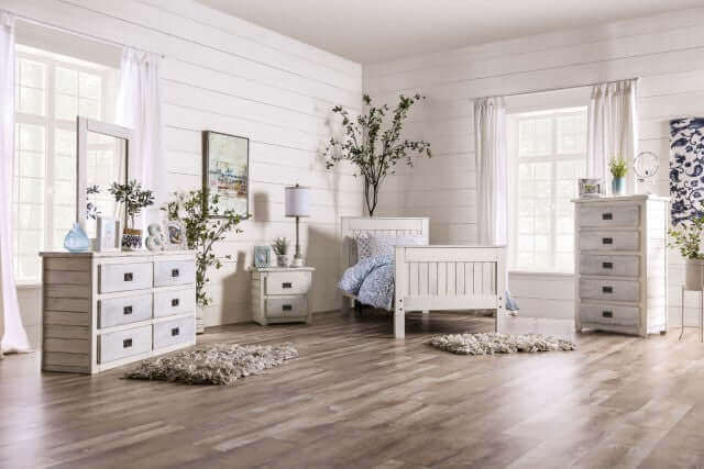 Cozy bedroom featuring a Rockwall white dresser, nightstand, and bed in a bright, airy space with wooden floors.