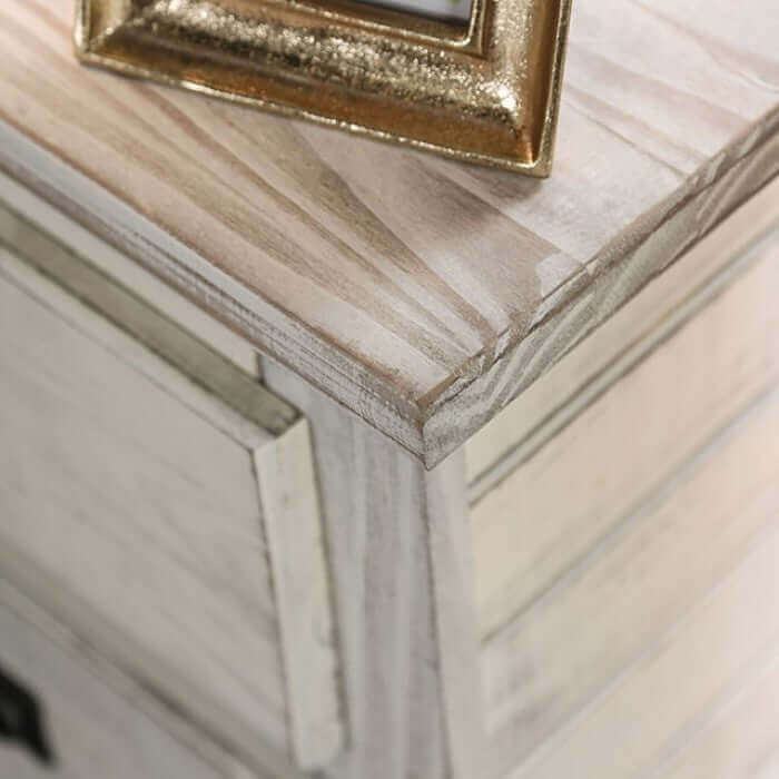 Close-up of the weathered barn finish on the Rockwall White Chest by FOA with a decorative frame.