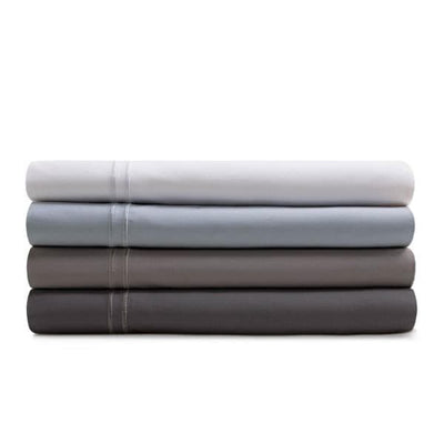 Stack of Malouf Premium Flax Natural Supima® Cotton Pillowcases in white, light gray, dark gray, and charcoal colors.