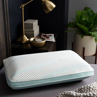 Tempur-Adapt ProHi Cooling Pillow by Tempur-Pedic on a modern nightstand with lamp and plants in the background.