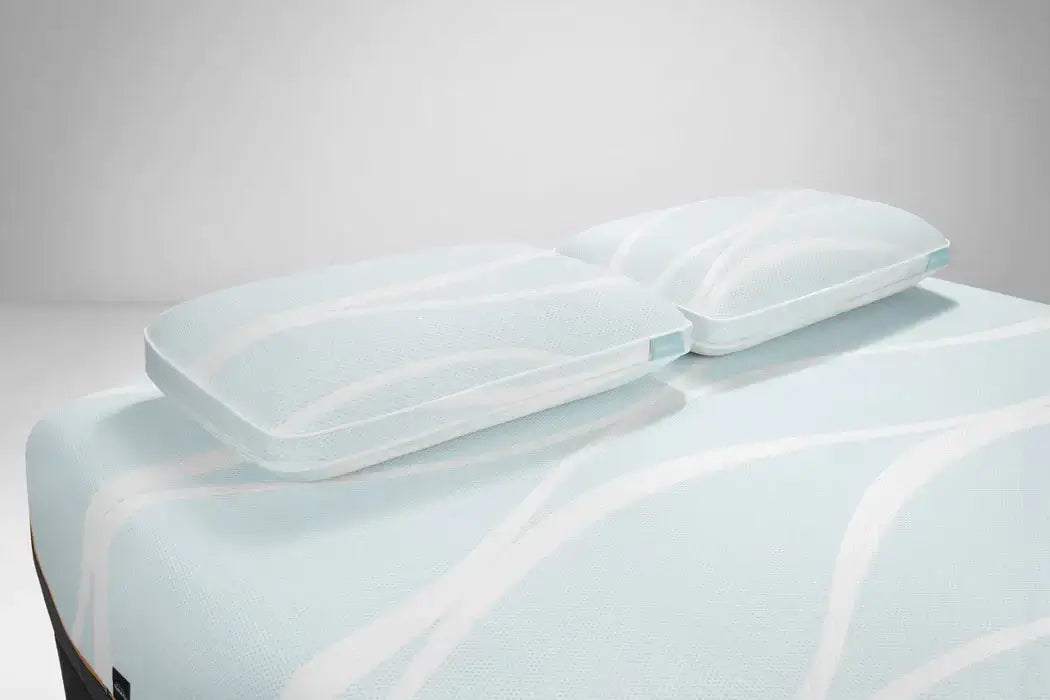 Tempur-Breeze° ProHi + Advanced Cooling pillows on a bed, featuring a cool-to-the-touch cover design.