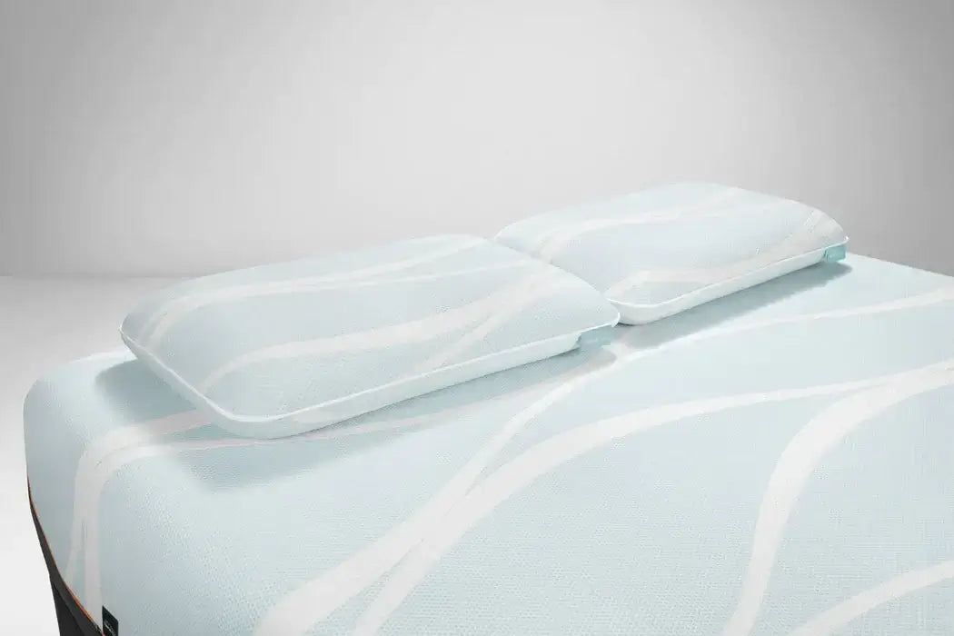 Tempur-Breeze° ProLo + Advanced Cooling Pillow with cool-to-touch cover on a mattress, designed for ultimate comfort.