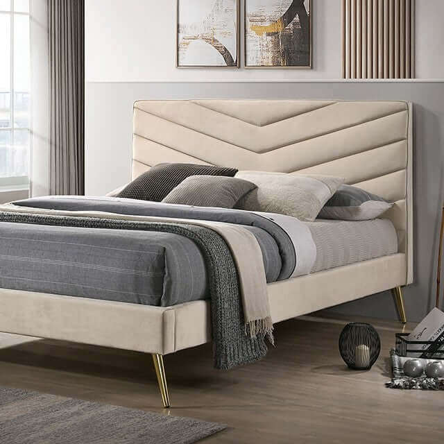 Mid-century modern beige bed with chevron tufted headboard and gold-plated legs in a stylish bedroom setting.