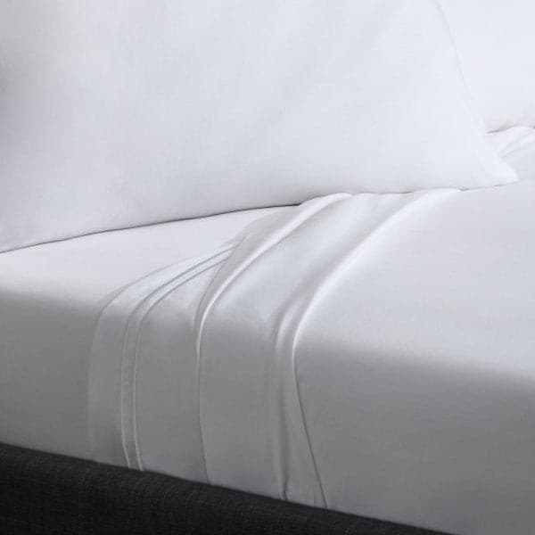 Soft white Supima cotton sheet set with deep pockets, showcasing luxurious sateen weave and elegant design.