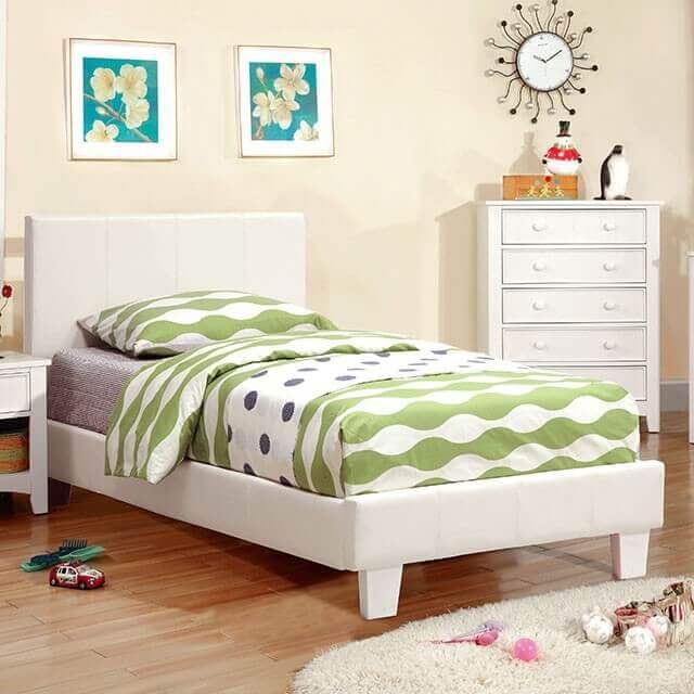 Contemporary white platform bed with padded headboard and green polka dot bedding in a bright bedroom setting.