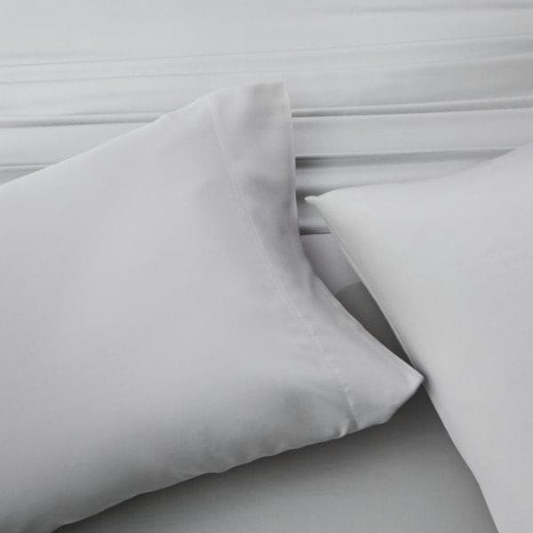 Soft gray pillows on silky bamboo rayon sheets, showcasing comfort and breathability for a restful night's sleep.