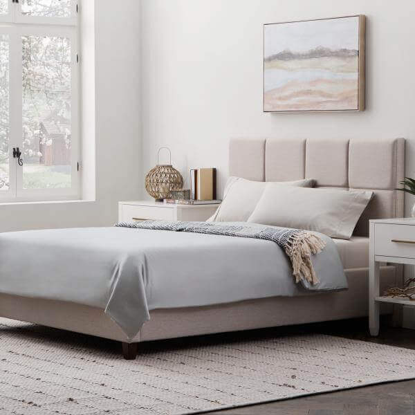 Cozy bedroom featuring Malouf Ash Soft Knit Microfiber Sheet Set on a modern bed with neutral decor and natural light.