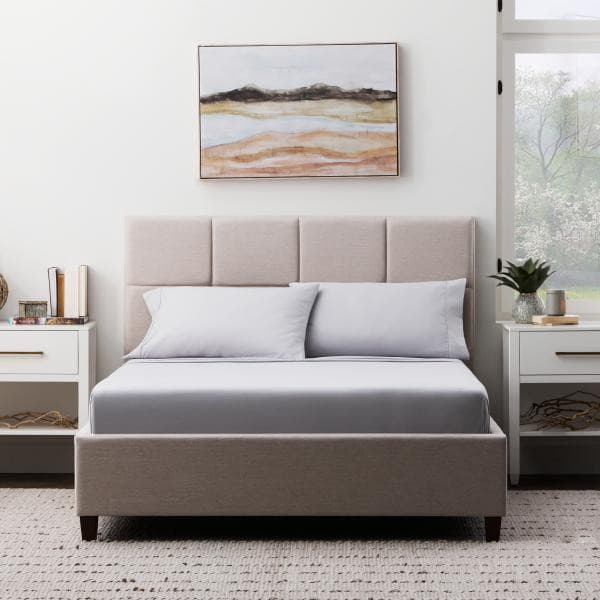 Cozy bedroom featuring a Malouf Ash Soft Knit Microfiber Sheet Set on a stylish bed with light decor.