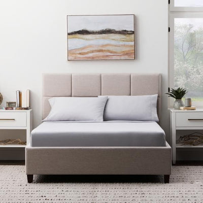 Cozy bedroom featuring a Malouf Ash Soft Knit Microfiber Sheet Set on a stylish bed with light decor.