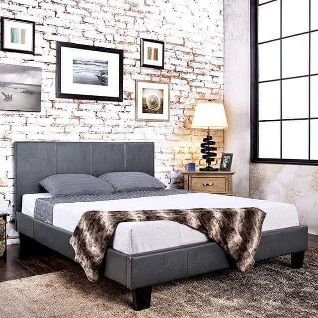 Contemporary Winn Park Gray Platform Bed with padded headboard, styled in a modern bedroom setting with decorative wall art.