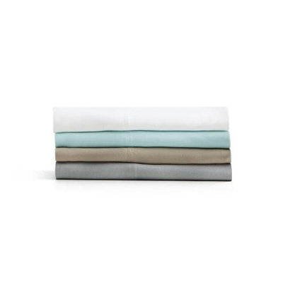 Four Malouf bamboo rayon pillowcases in white, mint green, taupe, and gray stacked neatly for a stylish bedroom look.