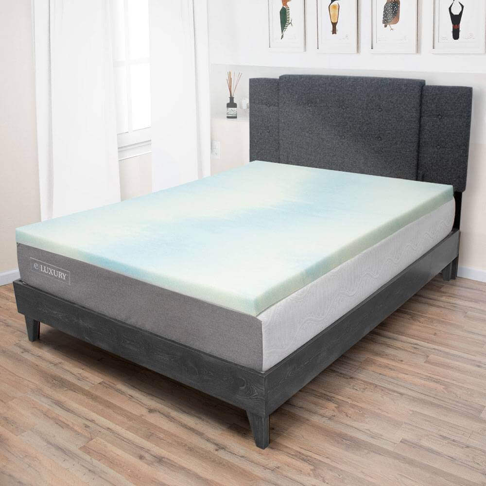 Temperature regulating gel memory foam mattress topper on a stylish bed frame in a cozy bedroom setting.