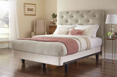 Stylish bedroom featuring a Knickerbocker enGauge™ bed frame with elegant upholstery and contemporary decor elements.