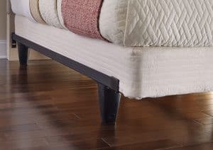 Knickerbocker enGauge™ hybrid bed frame with stylish tapered legs and plush mattress on wooden floor.