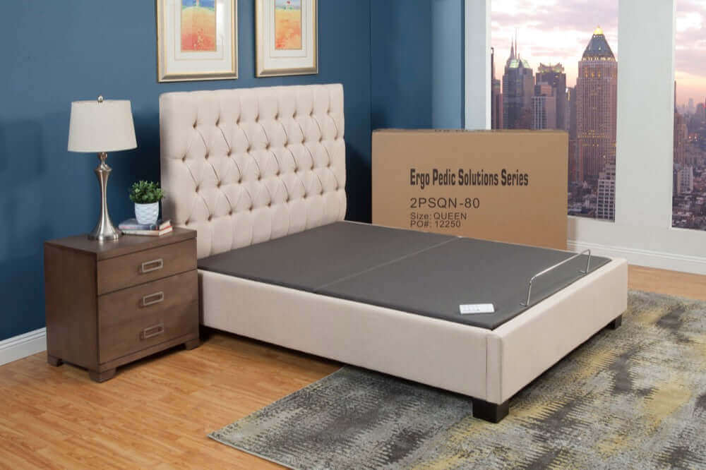Ergo-Pedic Solutions II Adjustable Bed Base in a modern bedroom setting with a skyline view, showcasing comfort and style.