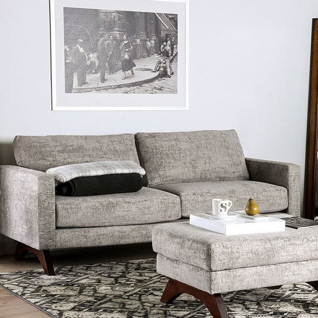Harlech Gray Mid Century Sofa in a modern living room setting with chic decor and cozy accessories.