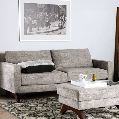 Harlech Gray Mid Century Sofa in a modern living room setting with chic decor and cozy accessories.