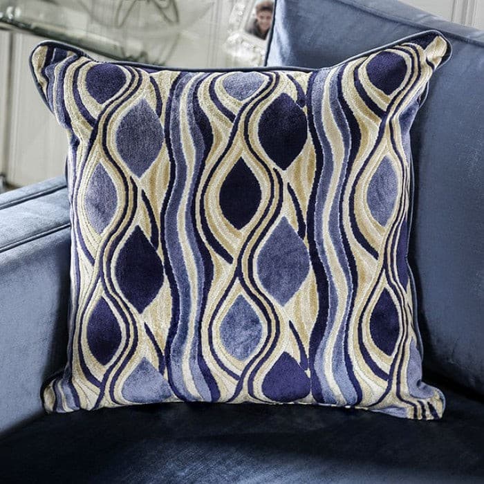 Decorative pillow featuring a surreal blue and gold pattern on a contemporary sofa. Perfect accent for modern decor.