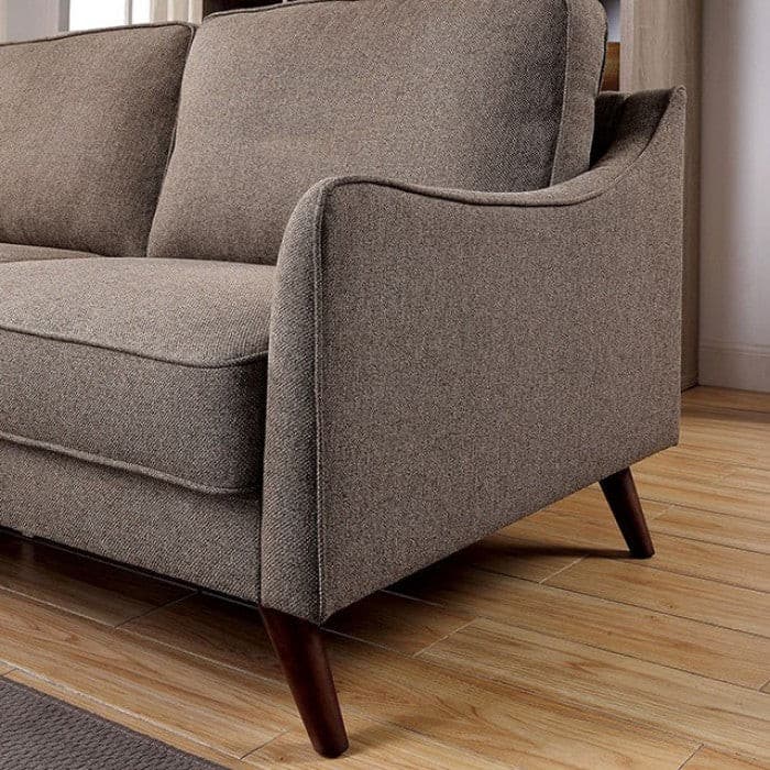 Mid-century modern light brown loveseat with tapered legs and curved track arms in a stylish living space.