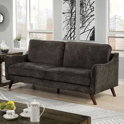 Maxime Dark Gray Mid Century Sofa with tapered legs and curved arms in a modern living room setting.