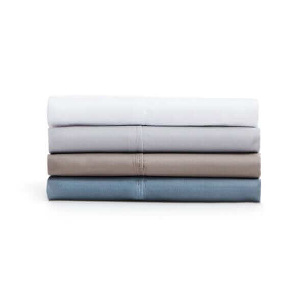 Soft knit microfiber sheet set in various colors stacked neatly, showcasing cozy and wrinkle-resistant fabric.