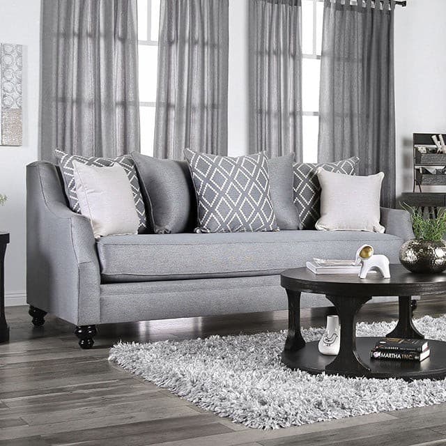 Nefyn Gray Transitional Sofa with decorative pillows in a cozy living room setting.